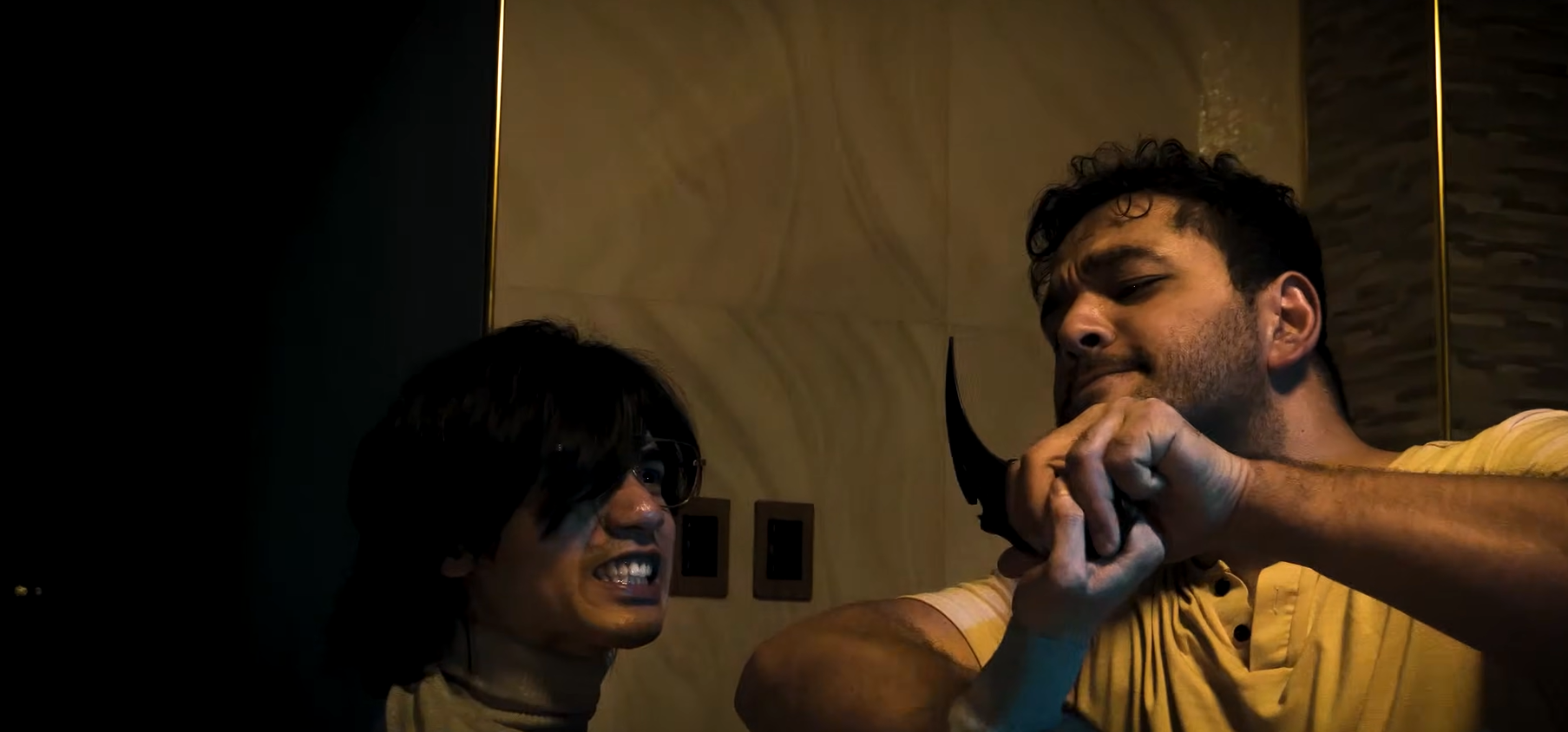 Two men struggle over a knife in Echoes of Death