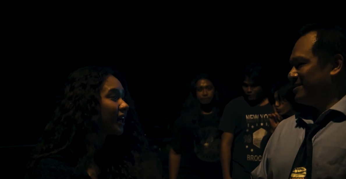 A woman confronts a group of men in Echoes of Death