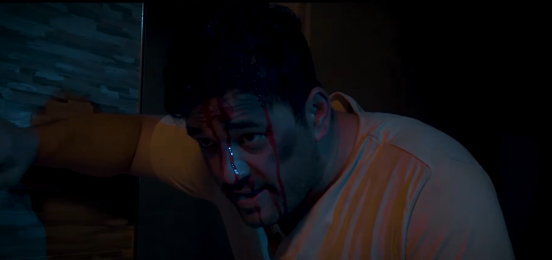 An injured man in a dark room in Echoes of Death
