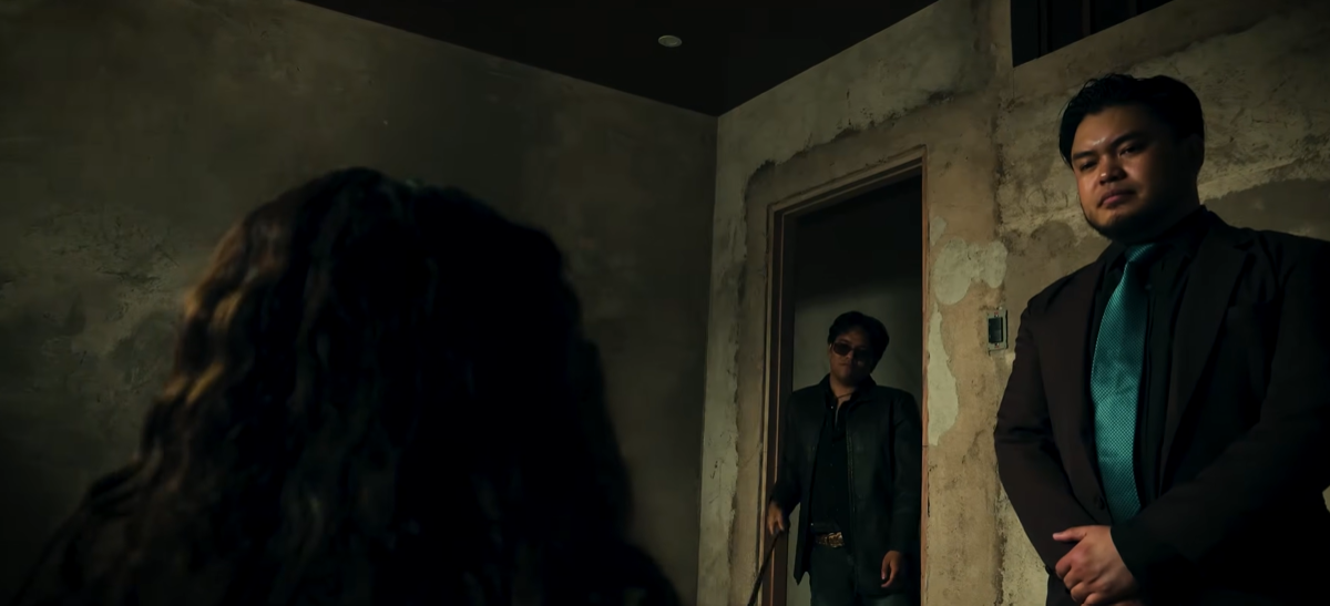 Two suited men enter a distressed room in Echoes of Death